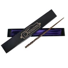 two harry potters wands in a black box with purple ribbon and blue packaging