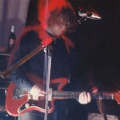 a man that is standing up with a guitar