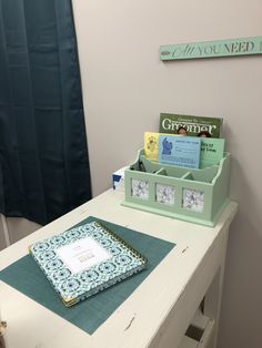 a desk with some books on it and a notepad in the drawer next to it