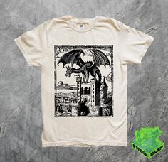 (all designs are printed on Comfort Colors premium T-shirts) This beautiful one of a kind Dragon Vintage Dark Art shirt is a Frog Cult original design. Handcrafted with love, printed with non-toxic water based ink, on premium 100% cotton washed tees. So comfy and aesthetic, your friends and fam will probably all be jealous. This shirt also makes the perfect gift! THE SPECS - High quality comfort colors T shirt - Comfortable unisex relaxed fit - 100% ringspun cotton - softwashed and pre-shrunk - Dragon Age T Shirt, 90s Tattoos, Y2k Tshirt, Art Dragon, Dragon Lover, Art Shirts, Beautiful One, Graphic Shirt, Lovers Gift