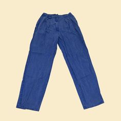 "Vintage Izod women's pants, manufactured ca. 1990s. 100% cotton size 12 pants with belt loop, pockets on both sides, and a zipper and button closure. These pants are thinner than typical denim, and have a pastel indigo hue.     - Brand: Izod    - Size: Women's 12    - Time Period: 1990s    - Color(s): Blue (indigo hue)    - Materials: 100% cotton    - Made in: Portugal    - Condition: In good vintage condition, with one minor marking on the back of the pants. Measurements:     - Inseam - 30\" 90s Denim Blue Wide Leg Bottoms, 90s Wide Leg Denim Blue Bottoms, 90s Style Wide Leg Denim Blue Bottoms, Vintage Denim Blue Cargo Jeans For Spring, Vintage Cargo Jeans In Denim Blue For Spring, Vintage Straight Leg Cargo Jeans For Spring, 90s Blue Straight Leg Cargo Jeans, 90s Style Dark Wash Wide Leg Pants, 90s Style Wide Leg Dark Wash Pants