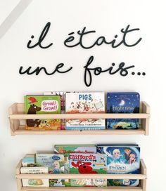 two wooden bookshelves with children's books on them and the words ill etait une fois