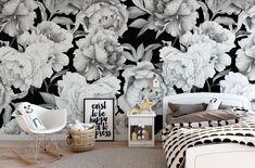 a bedroom with black and white flowers on the wall