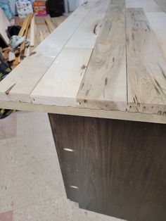 a table made out of wooden boards sitting on top of a floor