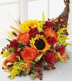 a bouquet of sunflowers and other flowers on a table