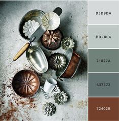 pans and other kitchen utensils are arranged on a gray surface with brown accents