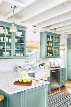 a kitchen with blue cabinets and white counter tops