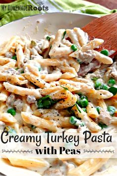 creamy turkey pasta with peas in a white bowl