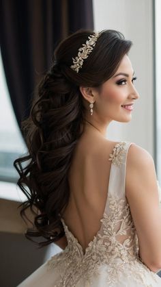 a woman in a wedding dress looking out the window