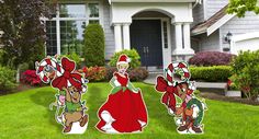 three paper cutouts of cartoon characters standing in front of a house with lawn decorations