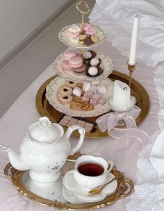 three tiered trays filled with cookies and pastries on top of a table