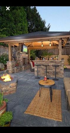 an outdoor living area with fire pit and seating