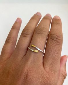 Introduce a touch of sophistication and edge to your jewelry collection with our Handcrafted Silver and Gold Plated Ring. This elegant piece is made from thick sterling silver round wire, carefully hammered and then gold plated on the tips for a beautiful silver and gold contrast. Simple and dainty, this ring is perfect for everyday wear or as a statement piece when paired with other silver, gold, or mixed metal jewelry. One of the best things about this ring is its versatility - it's a cuff ring, which means it's quite adjustable. The band is solid but can be pinched firmly to adjust the size. This means that you can wear it on any finger, and you don't have to worry about getting the perfect size. Just choose your size variation at checkout and we'll shape the ring to your specific size Simple Hammered Ring Jewelry, Hammered Open Ring For Promise, Minimalist Hammered Jewelry With Open Band, Unique Hammered Rings For Everyday Wear, Minimalist Hammered Open Band Jewelry, Delicate Hammered Ring Jewelry, Delicate Hammered Jewelry Ring, Dainty Hand Forged Rings For Everyday, Dainty Hammered Stackable Open Rings