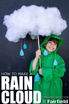 a young boy dressed in raincoats holding an umbrella with clouds above his head