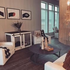 a living room filled with furniture and pictures on the wall