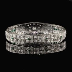 Stunning antique platinum bracelet with old european cut diamonds and emeralds. Item #B0024 Metal: Platinum Weight: 29.3 Grams Total Diamond Weight: Approximately 5.50 cts Diamond Color: H Diamond Clarity: VS2 - SI1 Measurements: 7 in x 5.5 mm Layaway: For your convenience, we will be happy to provide layaway payment options. Please contact us to work out a layaway plan which best suits your needs. All layaway purchases are final sale. All domestic and international shipments are shipped with Fe Formal Emerald Diamond Bracelet With Brilliant Cut, Formal Silver Diamond Bracelet With Emeralds, Formal Emerald Diamond Bracelet, Formal Silver Tennis Bracelet With Emeralds, Formal Silver Emerald Tennis Bracelet, Silver Emerald Tennis Bracelet For Formal Occasions, Formal White Gold Diamond Bracelet With Emerald, Emerald Diamond Bracelet In White Gold For Formal Events, Elegant Emerald Diamond Bracelet For Wedding