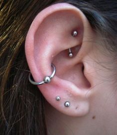 a woman with three piercings on her ear