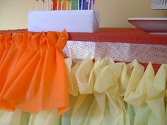 there are many bags on the table with some candles in them and one is orange