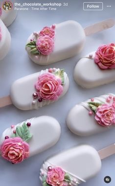 six wedding cakes with pink and white roses on each one, all decorated in fondant