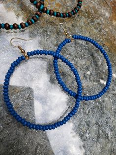 The Shades Of Blue Hoop Set, is a set of two pairs of hoop earrings, with a mix of beautiful turquoise and ocean blue, along with dark wood details. This earring set is also featured within the Beautiful Elegance Collection. Details: Lightweight Width: 2 inches Length: 2½ inches Consists of wood beads 18k gold plated hooks (nickel free)