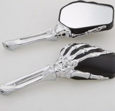 two skeleton hand mirrors sitting on top of each other