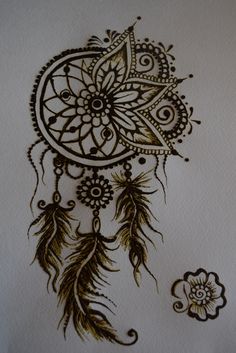 a drawing of a dream catcher with feathers on it's head and an intricate design