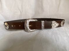 100% Genuine Leather  Australian Made  This is a 38mm (1 1/2") brown leather belt with a three piece Weston buckle set and big concord down the belt ( can be big and small conchos please ask) stitched in a brown  thread ( can be stitched in a silver thread, please ask) once you buy the belt just add a note to seller with the waist size you would like,  Waist size is from the buckle end of the leather to the middle hole then you will have three holes bigger and three holes smaller Brown Leather Belt Buckle With Antique Style, Brown Leather Belt Buckle With Antique Design, Brown Leather Belt Buckles With Antique Buckle, Brown Leather Belt Buckle With Antique Detail, Brown Leather Antique Belt Buckle, Brown Belt Buckle With Buckle Closure For Formal Occasions, Brown Formal Belt Buckle With Buckle Closure, Formal Brown Belt Buckle With Buckle Closure, Formal Brown Belt Buckle With Closure