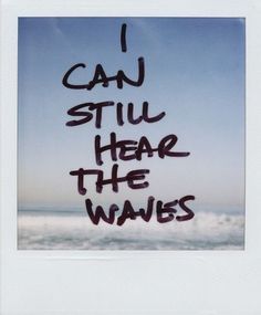 the words i can still hear the waves written in black ink on a blue sky background