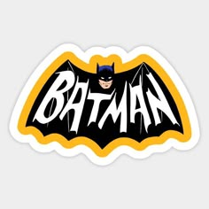 the batman logo sticker is shown in yellow and black with white letters on it