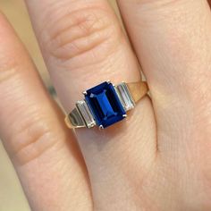 a woman's hand with a blue and white ring on top of her finger