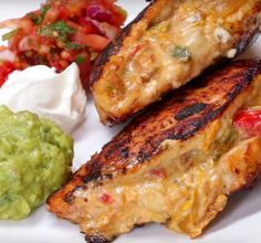 grilled fish with guacamole, salsa and sour cream on the side