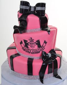 a pink cake with black bows on top