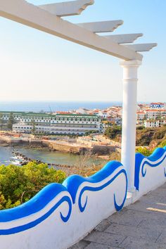 a white and blue balcony overlooking the ocean