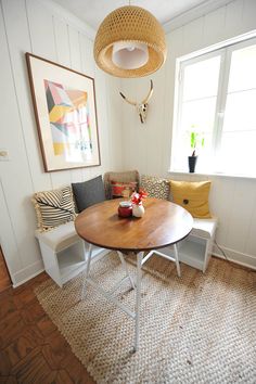 a living room with a table and two chairs