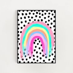 a white wall with black polka dots and a colorful rainbow painted on the inside of it