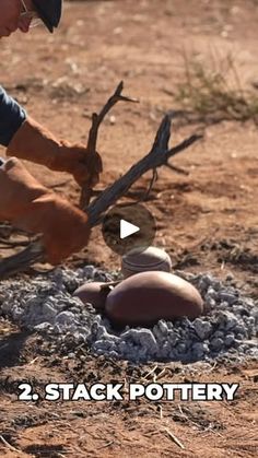 a man sitting on top of a pile of rocks next to an egg laying on it