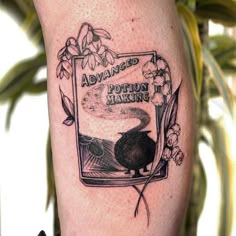 a black and white tattoo on the leg of a person's leg with an advert