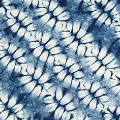 a blue and white tie - dyed background with small leaves