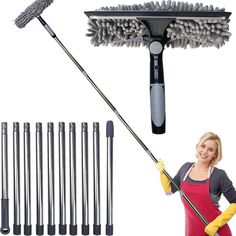 a woman in an apron holding a mop and cleaning wands next to several different types of brooms