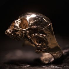 Our Bronze Halfjaw is a high-polished representation of an anatomically correct skull, of which the detail and accuracy is unparalleled. This piece is solid bronze and made to last centuries. In contrast to most other jewelry, wearing our skulljewelry will make it come to life even more. As weird as it may sound, due to scratches and dents, It will become more beautiful over time. Each piece is finished separately by hand to ensure perfect quality. *Attention! Due to the overwelming interest com Gold Skull-shaped Engraved Jewelry, Classic Engraved Skull Jewelry, Gold Skull Collectible Jewelry, Gold Skull Jewelry Collectible, Gold Skull Jewelry For Collectors, Luxury Skull Ring As Gift, Collectible Skull Jewelry In Lost Wax Casting, Gold Skull Shaped Collectible Ring, Gold Skull Ring Collectible