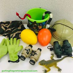 various items are displayed on a table with hats, gloves, and other things in front of them