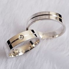 two wedding bands with a diamond in the middle