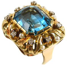 A aquamarine, pearl and diamond ring in a floral design in yellow gold from the Retro period, 1940s. The ring centres a big aquamarine, ca. 16 carats and it is accentuated by round brilliant cut diamonds and pearls. Aquamarine Ring Vintage, Vintage Cluster Ring, Enchanted Jewelry, Gemstone Rings Vintage, Rings Luxury, Estate Ring, Pearl And Diamond Ring, Vintage Fine Jewelry, Retro Ring