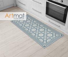 a blue and white kitchen rug in front of an oven