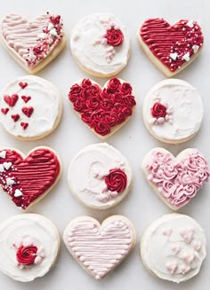 twelve decorated cookies arranged in the shape of hearts