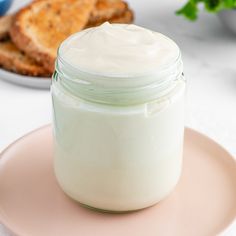 a jar of cream sitting on top of a plate