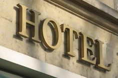 a hotel sign on the side of a building that says,'hotel'in gold letters