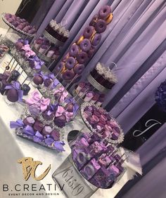 the table is covered with purple and silver desserts