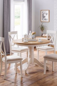 a dining room table with four chairs around it