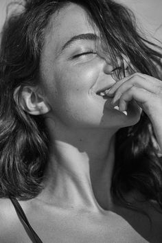 a black and white photo of a woman brushing her teeth